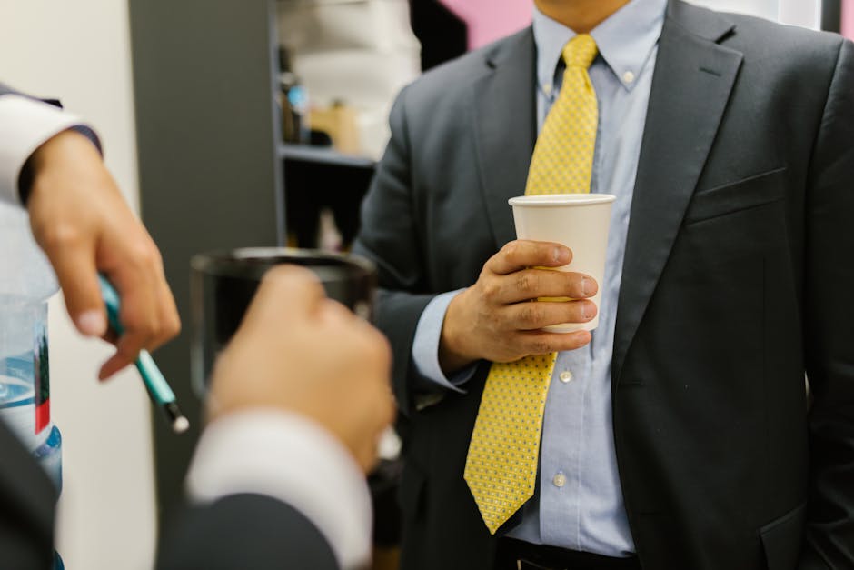 Two members of a professional community in conversation over coffee during a structured member engagement moment