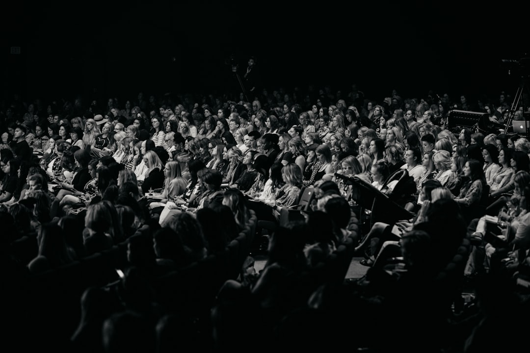 Full auditorium of attendees whose experience reveals the perception gap in event networking