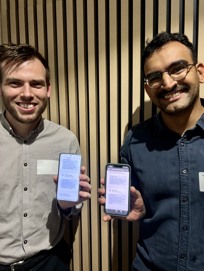 Two attendees comparing their match cards on their phones